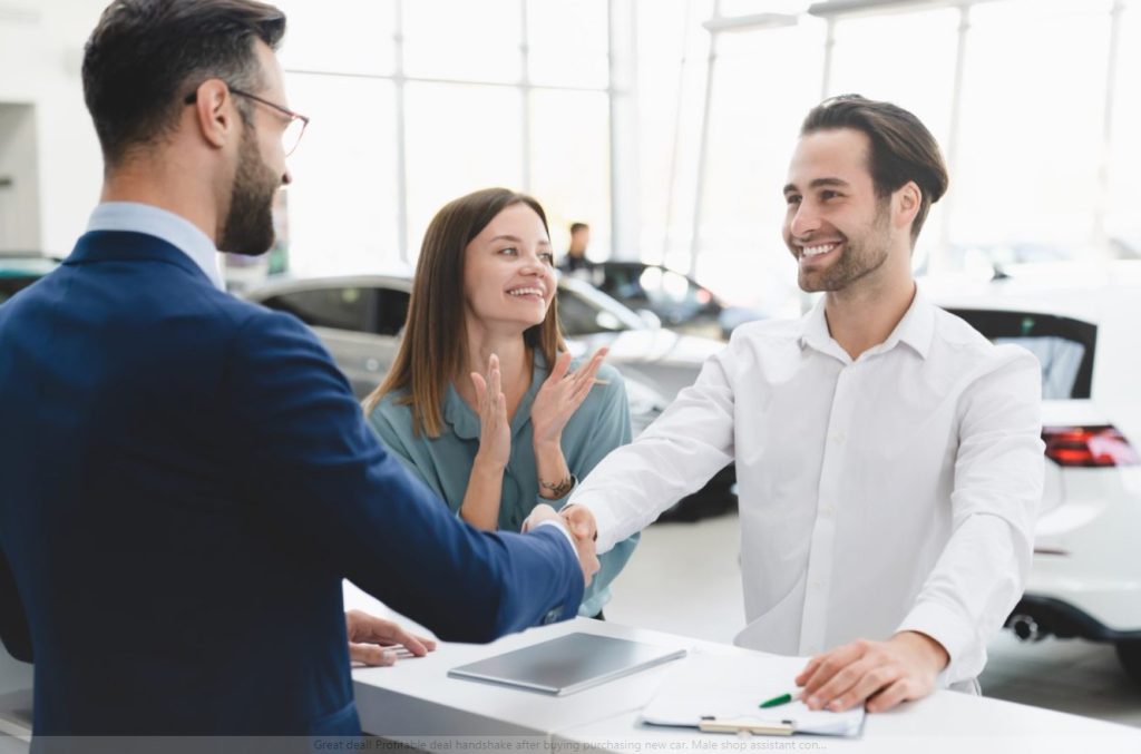 A man and a women incredibly happy with huge smiles shaking hands with their finance expert at Allen Tillery Auto because they got approved for their brand new vehicle.