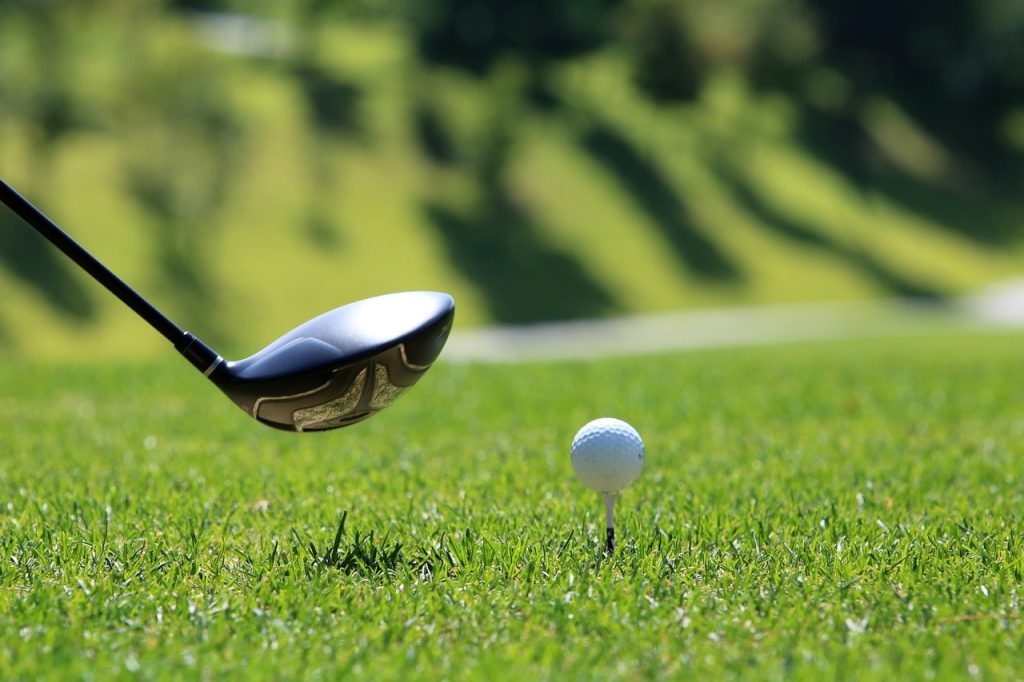 close up shot of a club about to hit a golf ball