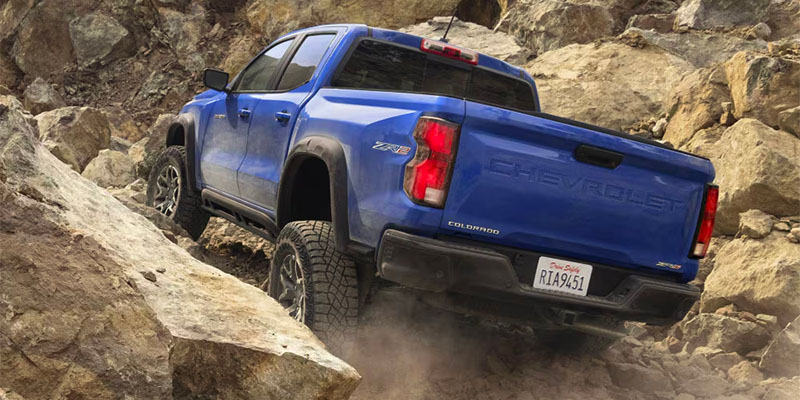 2025 Chevrolet Colorado driving up a rocky mountain
