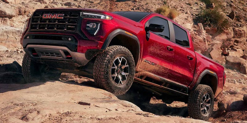 2026 GMC Canyon shown at an angle on unpaved ground